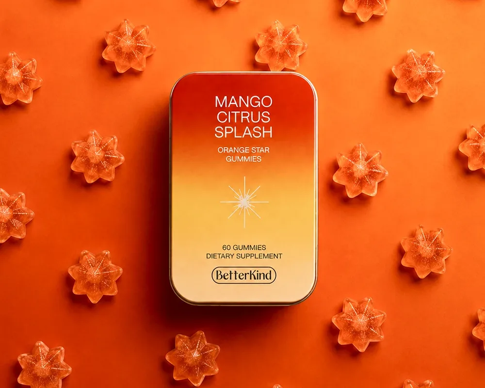 Betterkind mango gummy tin on a bed of orange star gummies