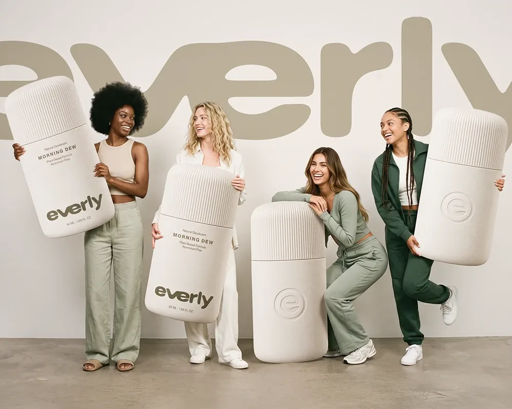 Four people holding giant Everly deodorant packs